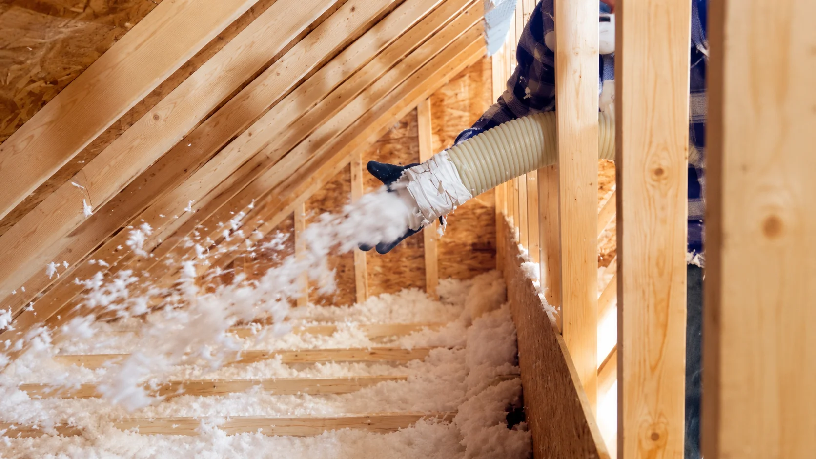 Insulation installation in attic with a blower